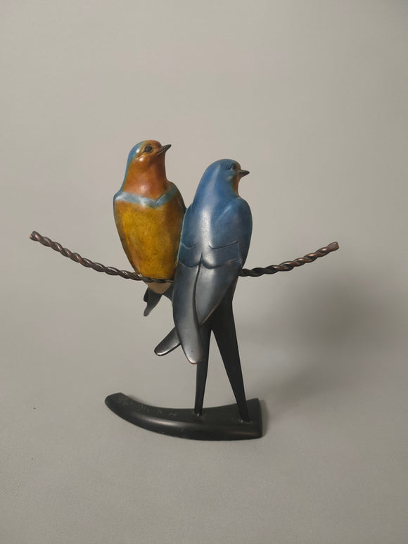 Twin swallows on a wire
