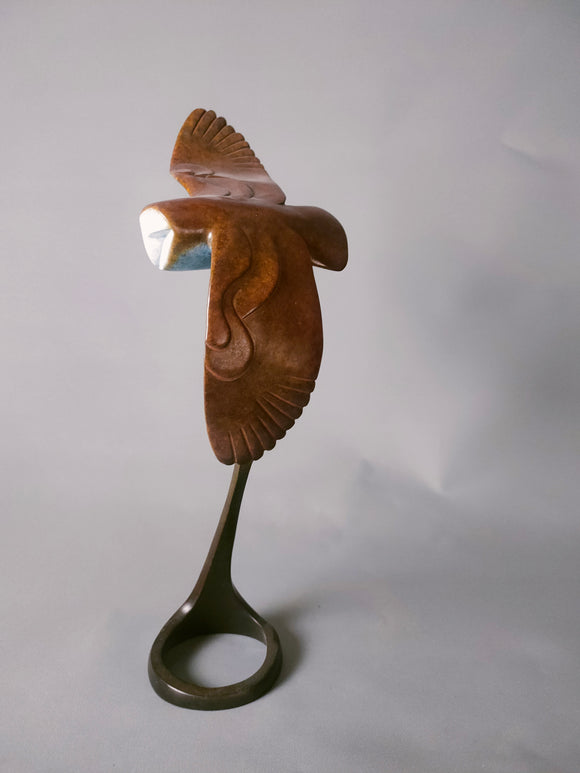 Miniature barn owl in flight
